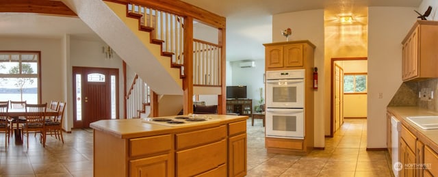 kitchen with tasteful backsplash, white appliances, tile countertops, and a wealth of natural light