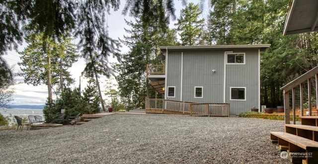 rear view of property featuring a wooden deck