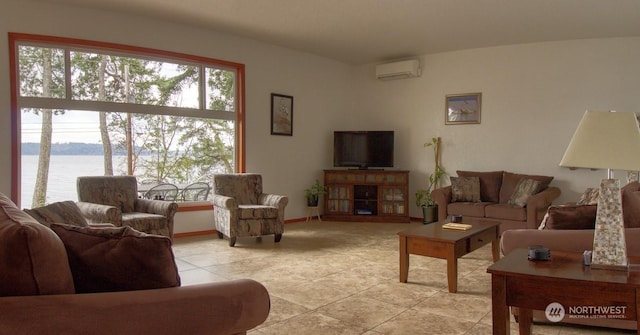 living room with a water view, light tile patterned floors, and an AC wall unit