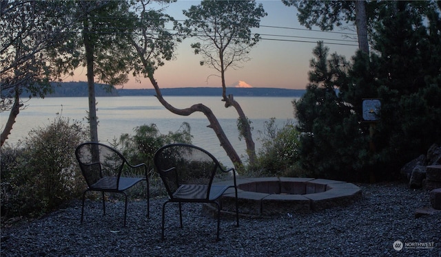 view of water feature with an outdoor fire pit