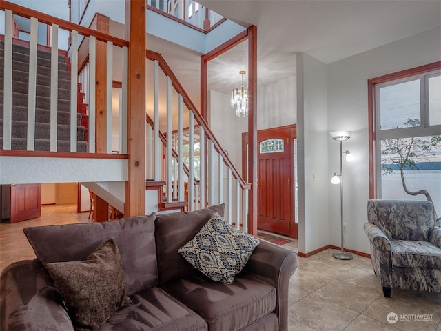 living room featuring a notable chandelier, light tile patterned flooring, and a water view