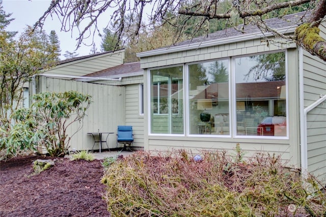 view of property exterior featuring a sunroom