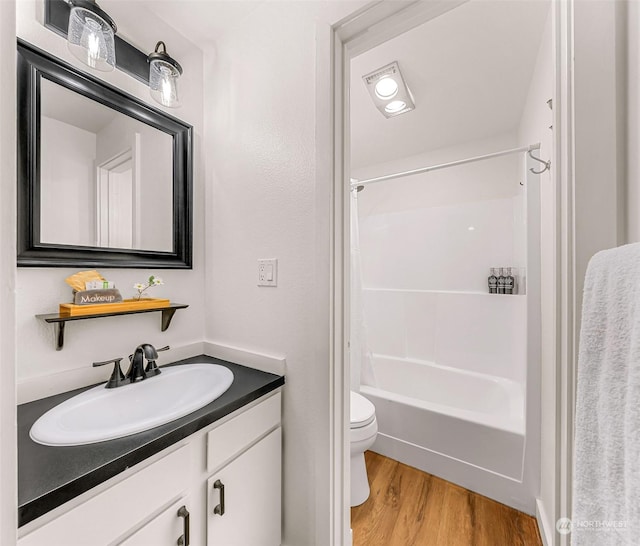 full bathroom featuring shower / bath combo, hardwood / wood-style floors, vanity, and toilet