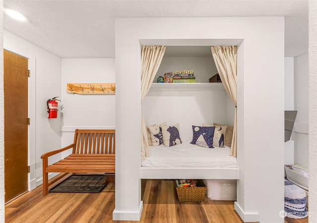 mudroom with hardwood / wood-style flooring and a textured ceiling