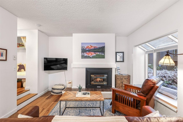 living room featuring hardwood / wood-style flooring and a textured ceiling