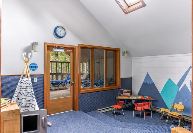 rec room featuring lofted ceiling with skylight and carpet