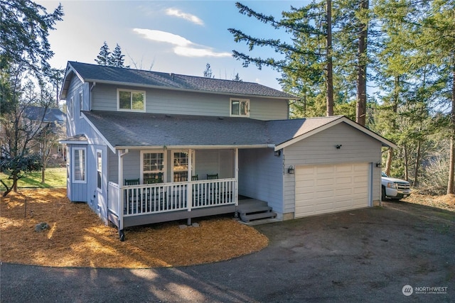 front of property featuring a porch and a garage