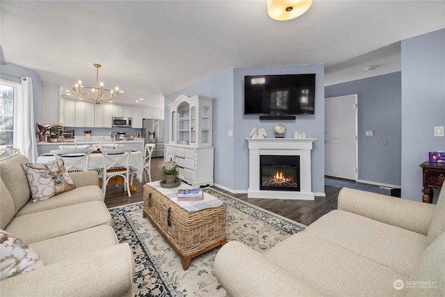 living room featuring hardwood / wood-style flooring and an inviting chandelier