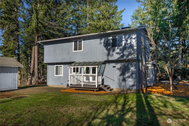 rear view of property featuring a lawn