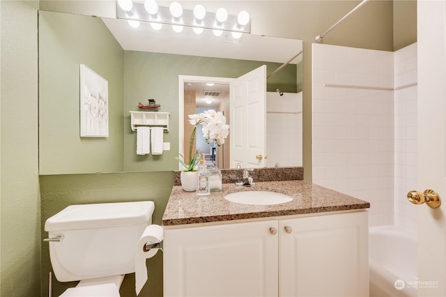 full bathroom featuring tub / shower combination, toilet, and vanity