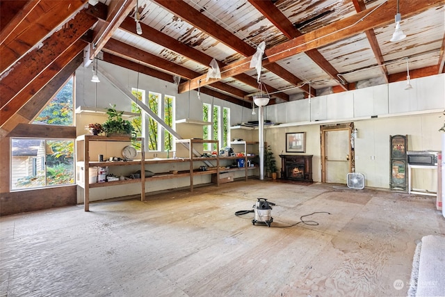 misc room with beam ceiling, high vaulted ceiling, and a wealth of natural light