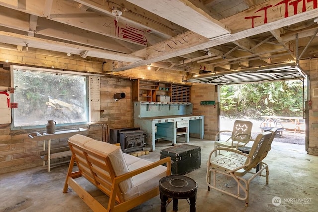 interior space with a wood stove and concrete floors