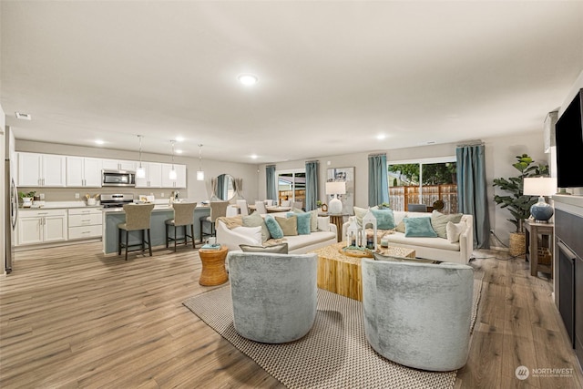 living room with light hardwood / wood-style flooring