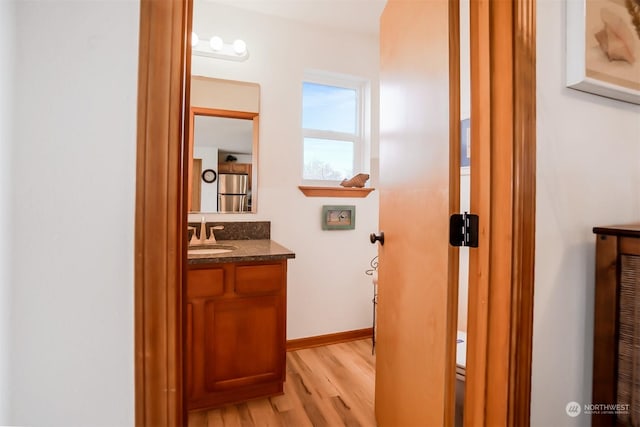 hallway with sink and light wood-type flooring