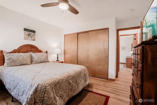 bedroom featuring ceiling fan, a closet, and light wood-type flooring