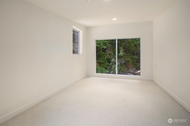 carpeted empty room with recessed lighting and baseboards