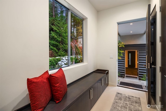 interior space featuring baseboards and light tile patterned floors