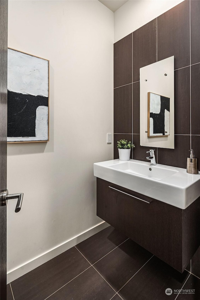 bathroom featuring tile patterned flooring, baseboards, and vanity