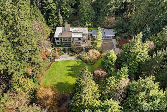 birds eye view of property with a wooded view