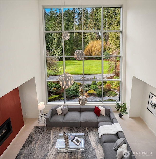 living room with a fireplace and tile patterned flooring