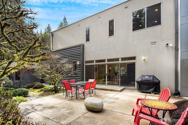 view of patio / terrace featuring outdoor dining space and a grill