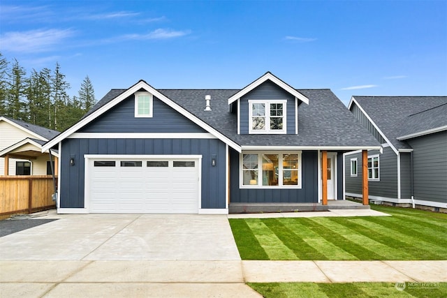 view of front of property featuring a garage and a front yard