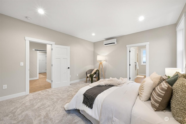 carpeted bedroom with ensuite bath and an AC wall unit