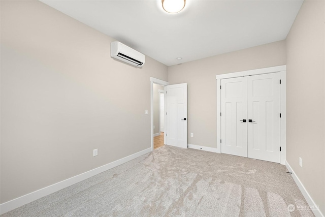 unfurnished bedroom featuring a wall mounted air conditioner, light carpet, and a closet