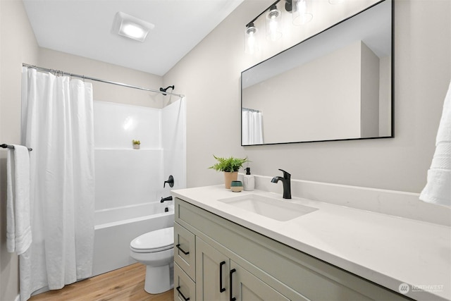 full bathroom with hardwood / wood-style flooring, vanity, shower / bath combo, and toilet