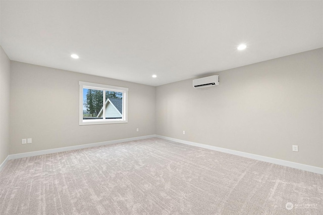 empty room with light colored carpet and a wall mounted air conditioner