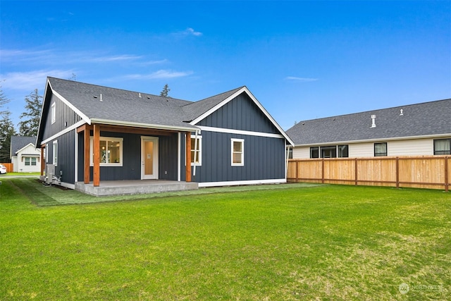 rear view of house featuring a patio and a lawn