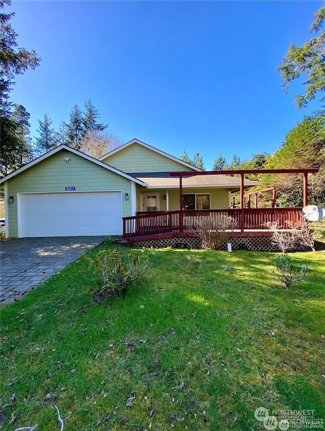 view of front of property with a garage, a front yard, and a deck