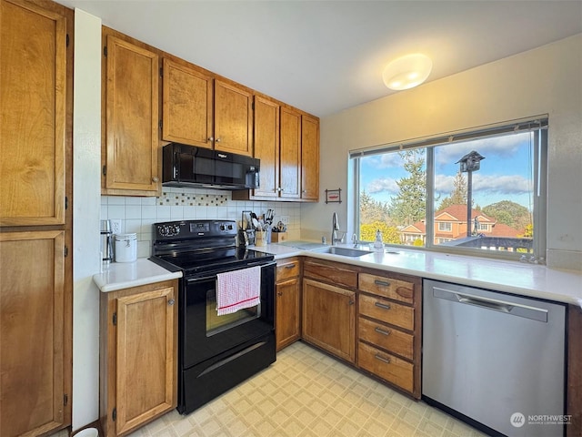 kitchen featuring sink, decorative backsplash, and black appliances