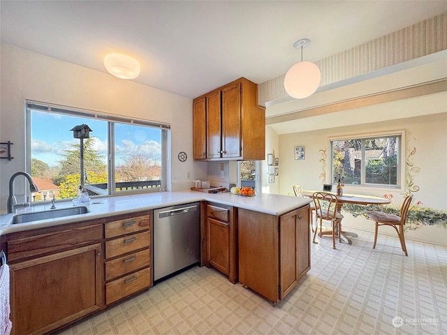 kitchen with sink, dishwasher, hanging light fixtures, plenty of natural light, and kitchen peninsula