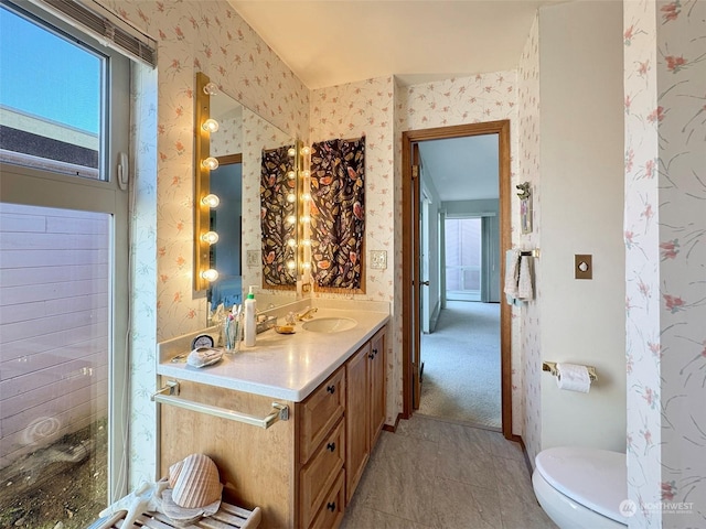 bathroom featuring tile patterned flooring, vanity, and toilet