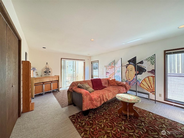 living room with baseboard heating and carpet floors