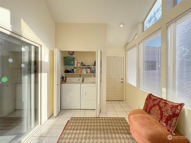 washroom with light tile patterned floors and washing machine and clothes dryer