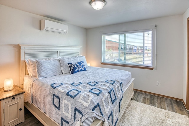 bedroom with a wall mounted air conditioner and dark hardwood / wood-style flooring