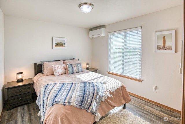 bedroom featuring dark hardwood / wood-style floors and a wall mounted AC