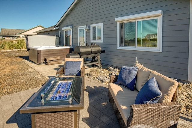 view of patio / terrace featuring grilling area, a hot tub, and an outdoor living space with a fire pit