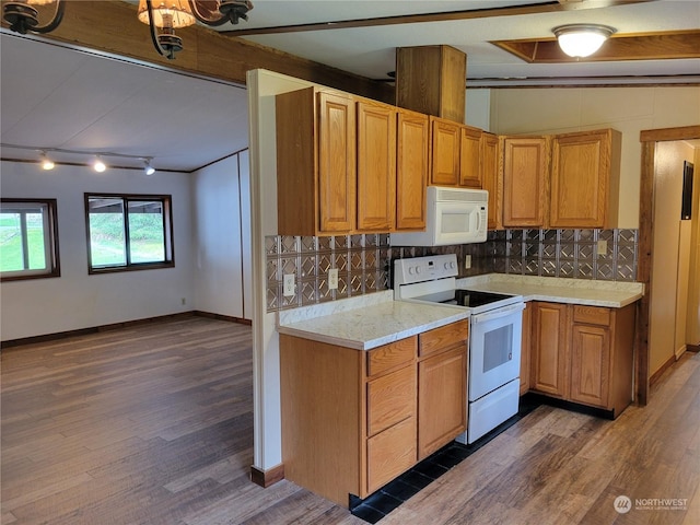 kitchen with decorative backsplash, light stone counters, white appliances, and dark hardwood / wood-style flooring