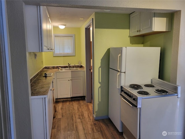 kitchen with hardwood / wood-style floors, a textured ceiling, white cabinets, white electric range oven, and sink