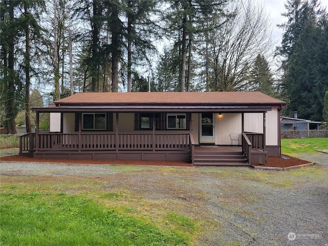 view of front of property with a porch and a front lawn