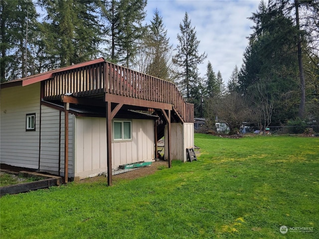 view of side of property with a lawn and a deck