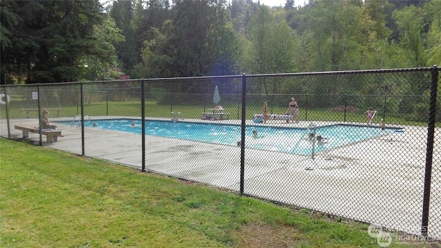 view of pool with a yard