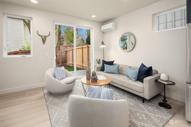 living room featuring hardwood / wood-style floors and a wall mounted air conditioner