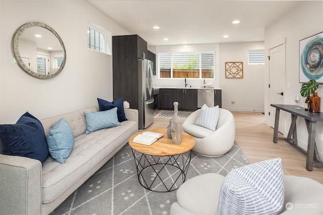 living room with sink and light hardwood / wood-style floors