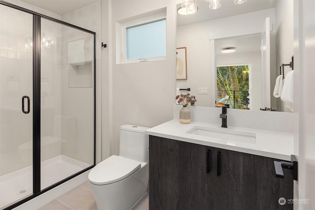 bathroom with toilet, tile patterned flooring, an enclosed shower, and vanity