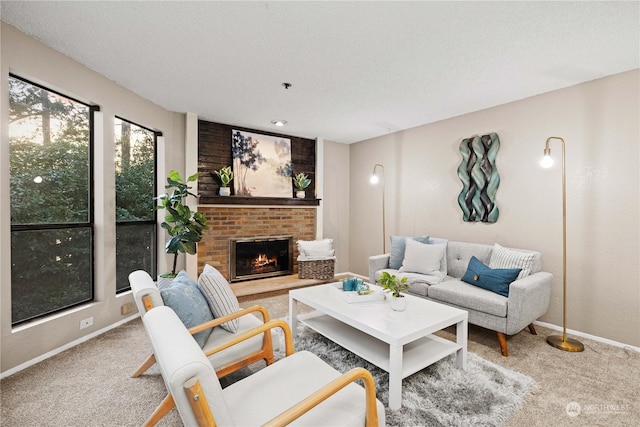 living room with a brick fireplace, a textured ceiling, and carpet flooring