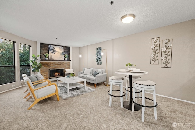 carpeted living room with a fireplace and a textured ceiling